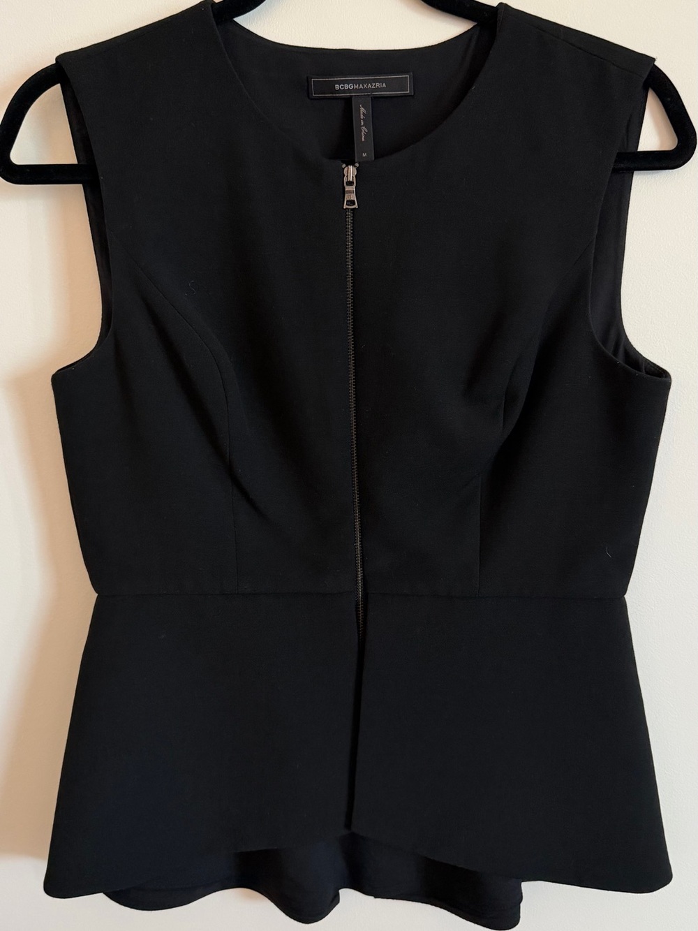 Women's black zip-front garment neckline